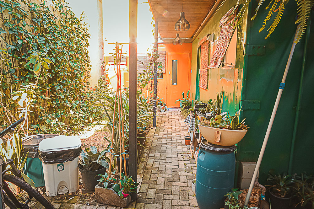Garden corridor between the container homes at golden hour