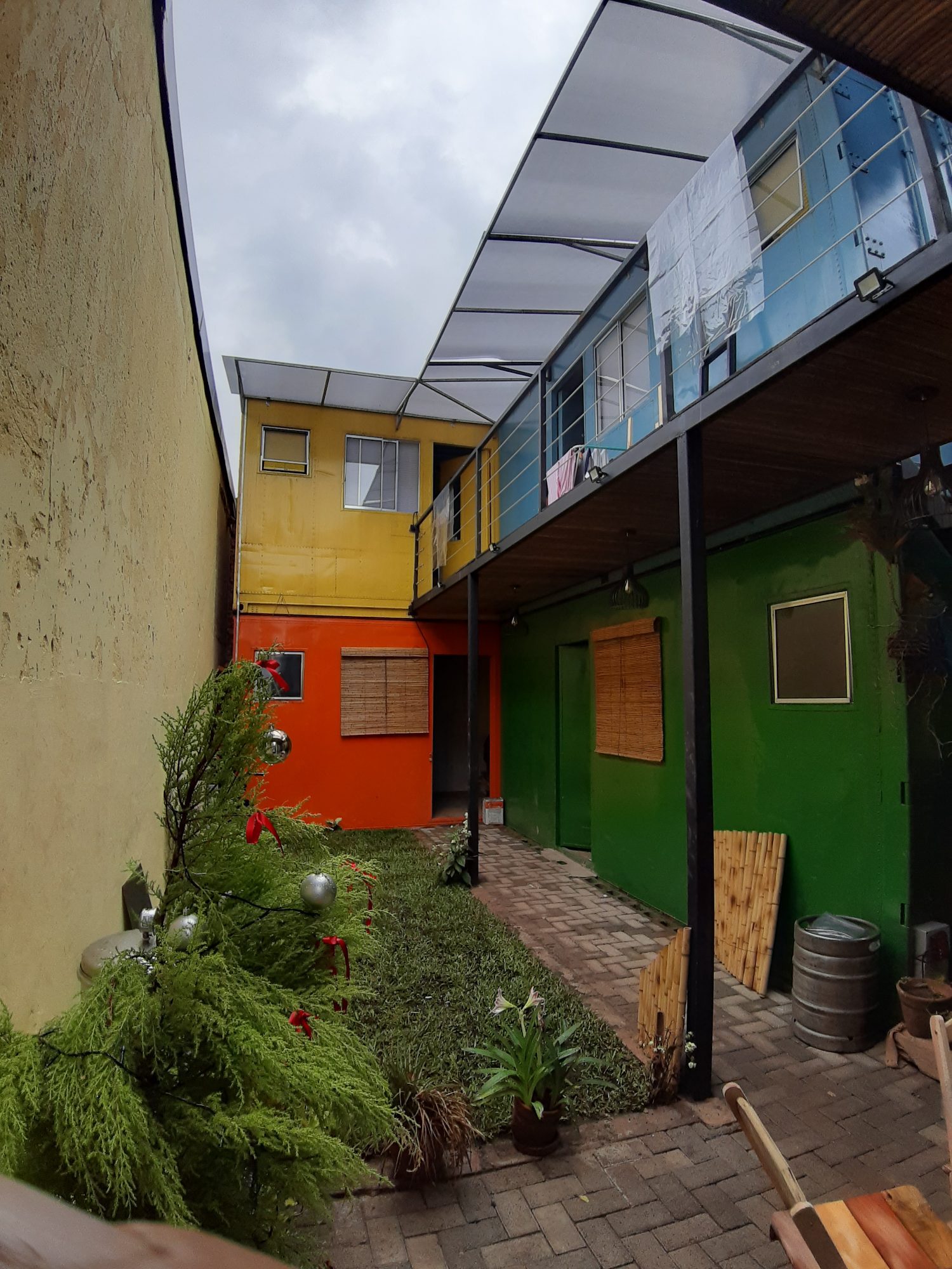 Colourful container courtyard with a garden at Teu Living