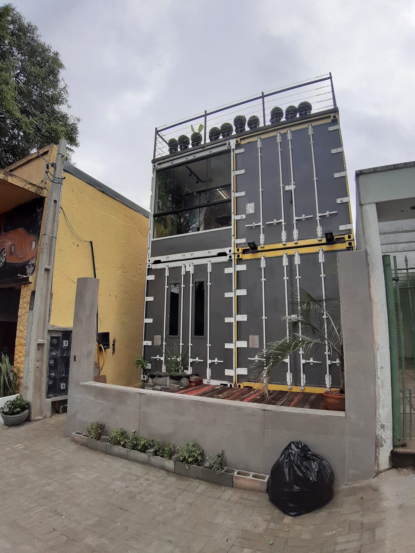 Front of the house — three shipping containers stacked into a home